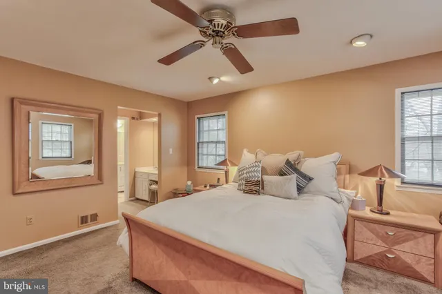 a bedroom with a large bed and a chandelier