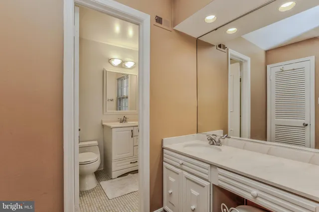 a bathroom with a sink a toilet and a mirror