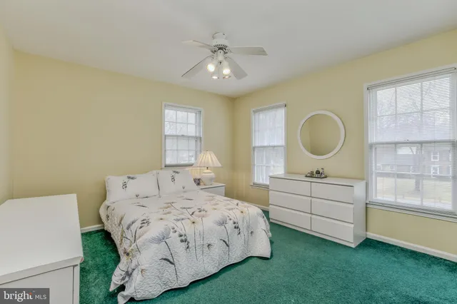 a bedroom with a large bed and window
