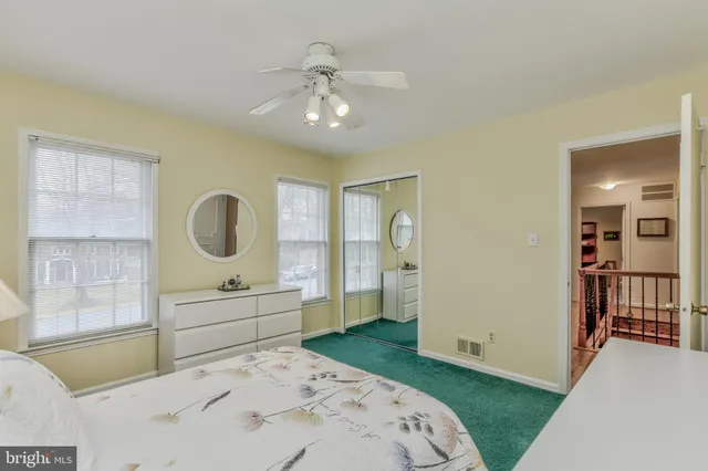 a bedroom with a large bed and wooden floor