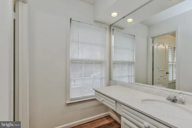 a bathroom with a granite countertop sink mirror and shower