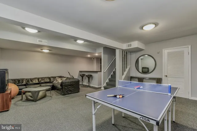 a room with furniture a mirror and a wooden floor