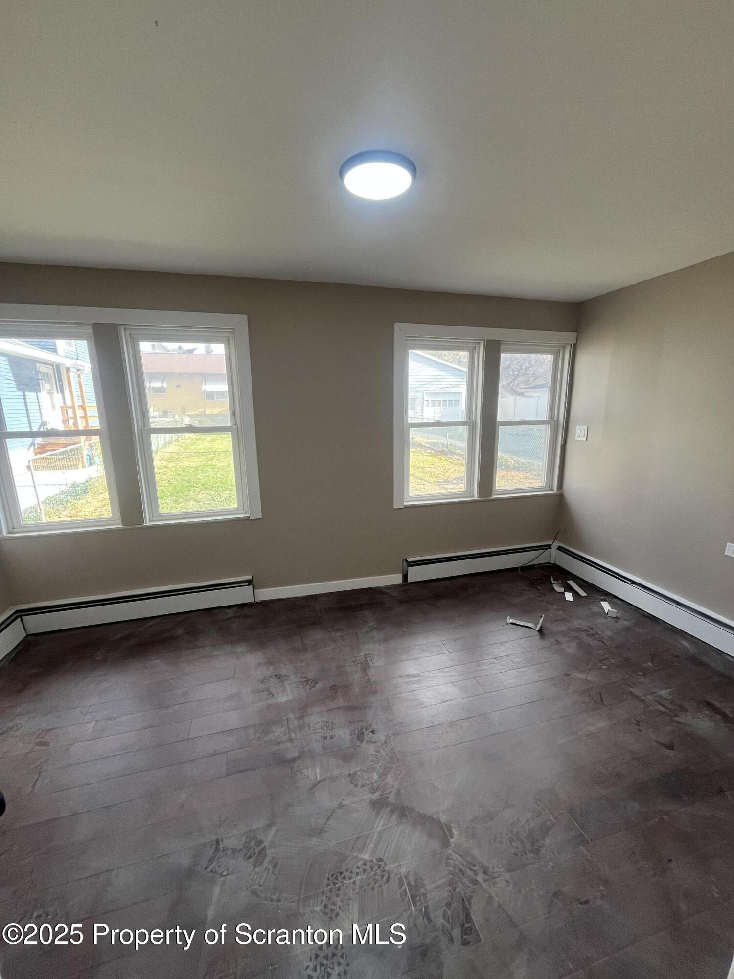 129 South Blakely Street, Unit 1 Dunmore, PA 18512 - Photo 4 of 6 an empty room with windows