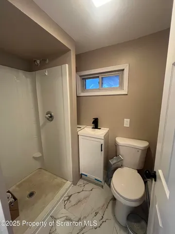 a white toilet sitting next to a bathroom sink