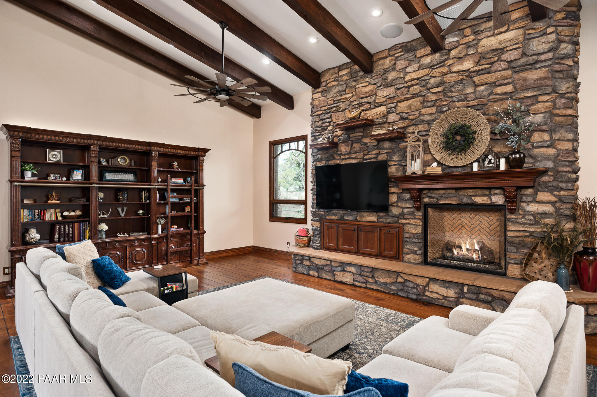 5350 West Three Forks Road Prescott, AZ 86305 - Photo 17 of 90 a living room with furniture a flat screen tv and a fireplace