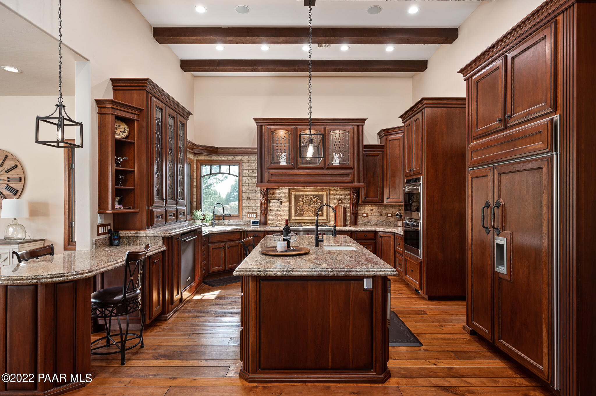 5350 West Three Forks Road Prescott, AZ 86305 - Photo 20 of 90 a kitchen with stainless steel appliances granite countertop a refrigerator a sink dishwasher a stove and a dining table with wooden floor