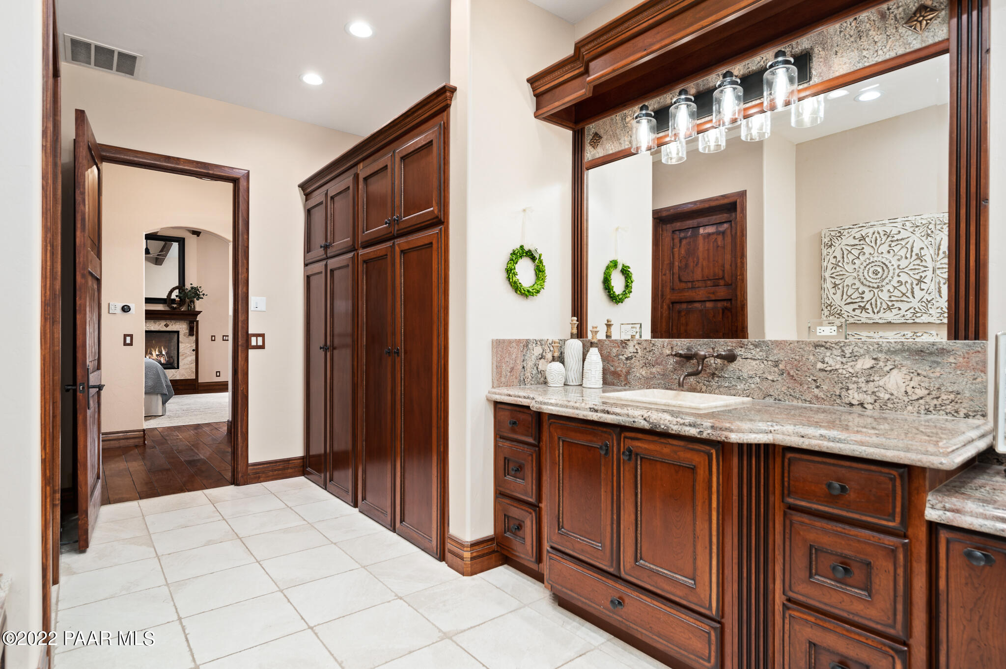 5350 West Three Forks Road Prescott, AZ 86305 - Photo 36 of 90 a bathroom with a granite countertop sink and a mirror