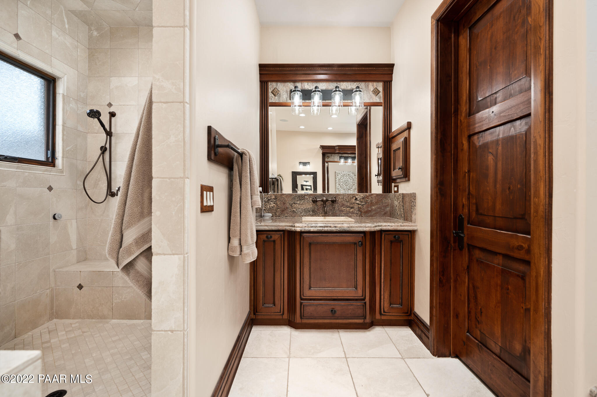 5350 West Three Forks Road Prescott, AZ 86305 - Photo 37 of 90 a bathroom with a granite countertop sink a toilet and shower