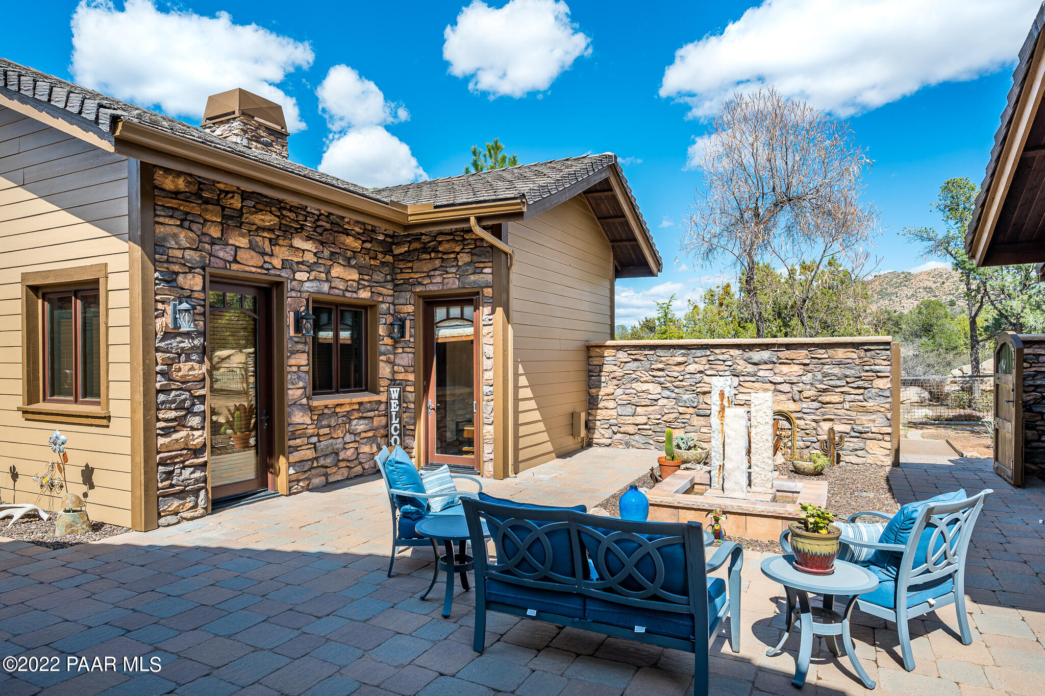 5350 West Three Forks Road Prescott, AZ 86305 - Photo 46 of 90 a view of a patio with table and chairs with wooden floor and fence