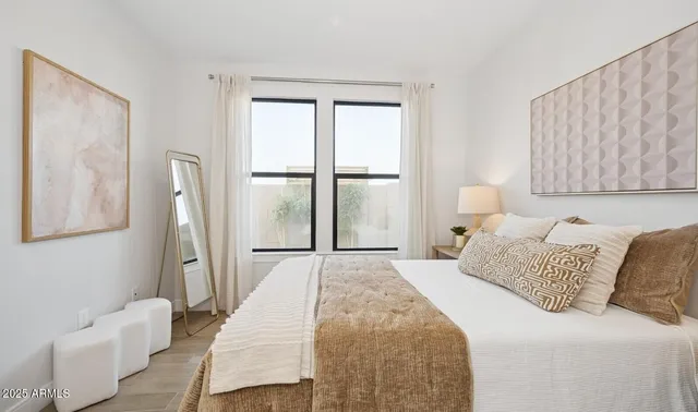 a bedroom with a bed and a couch