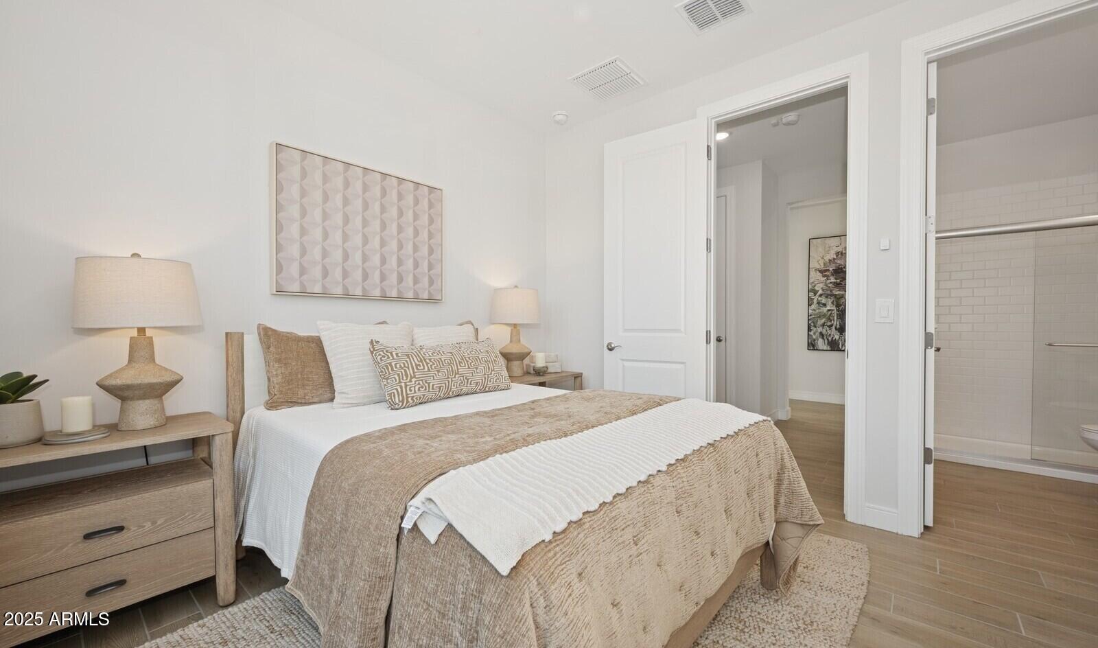 8046 West Royal Palm Road Peoria, AZ 85345 - Photo 12 of 31 a bedroom with a bed and wooden floor