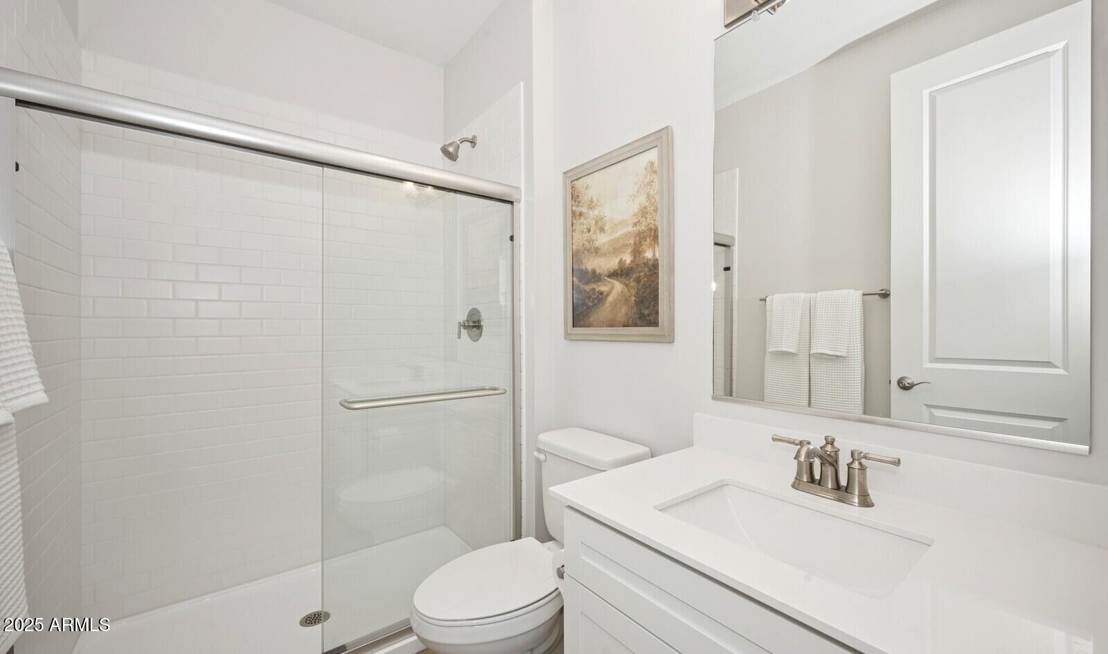 8046 West Royal Palm Road Peoria, AZ 85345 - Photo 13 of 31 a bathroom with a sink a toilet and shower
