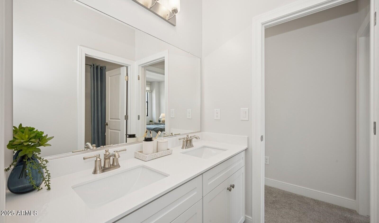 8046 West Royal Palm Road Peoria, AZ 85345 - Photo 22 of 31 a bathroom with a sink and a mirror