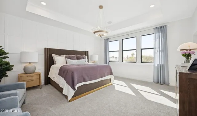 a spacious bedroom with a bed and a window