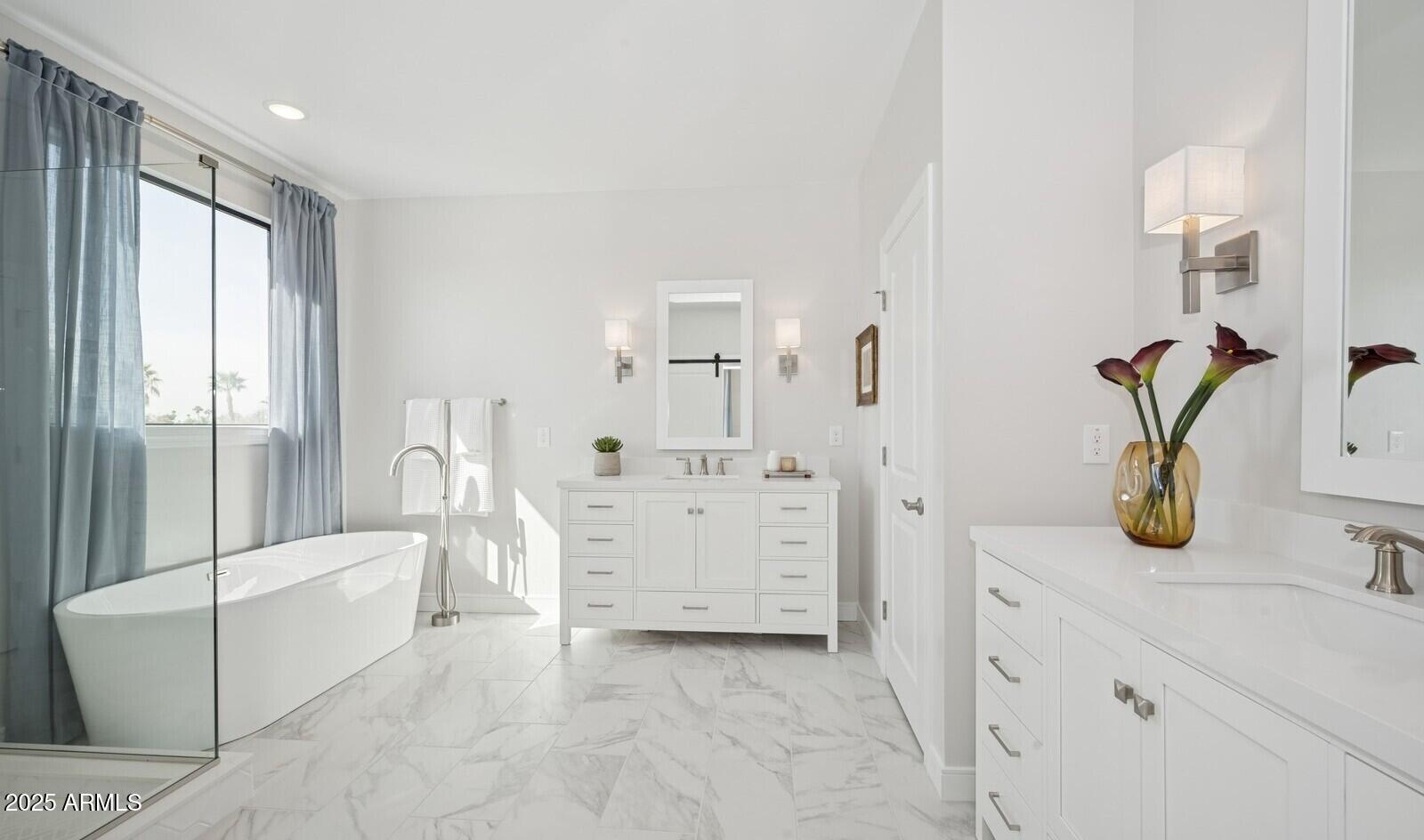 8046 West Royal Palm Road Peoria, AZ 85345 - Photo 29 of 31 a bathroom with a tub sink and mirror