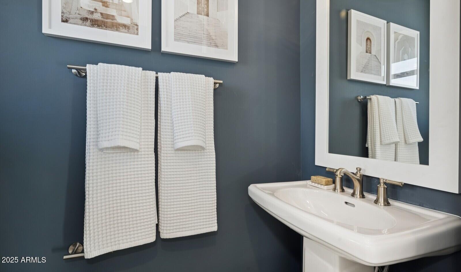 8046 West Royal Palm Road Peoria, AZ 85345 - Photo 10 of 31 a bathroom with a sink and a mirror