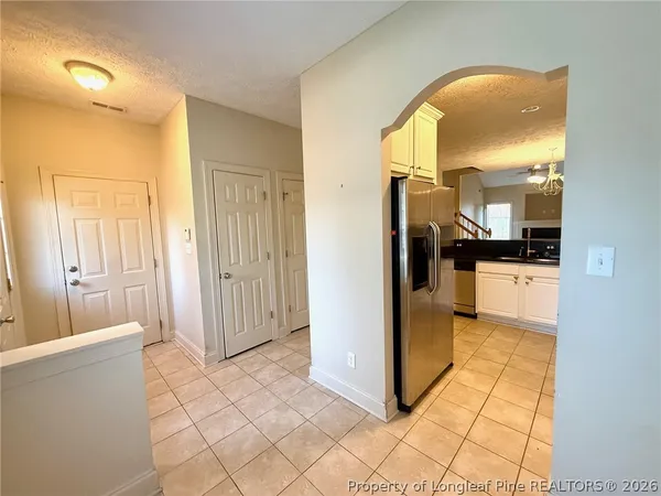 a view of a hallway view with wooden floor and a bathroom
