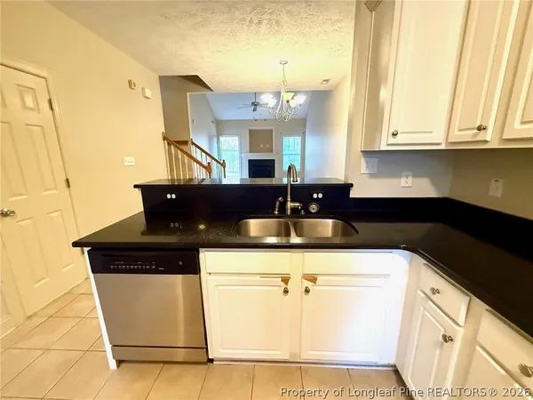 a kitchen with stainless steel appliances a stove a refrigerator a sink a counter top space and cabinets