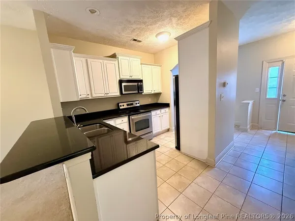 a kitchen with a stove microwave and sink