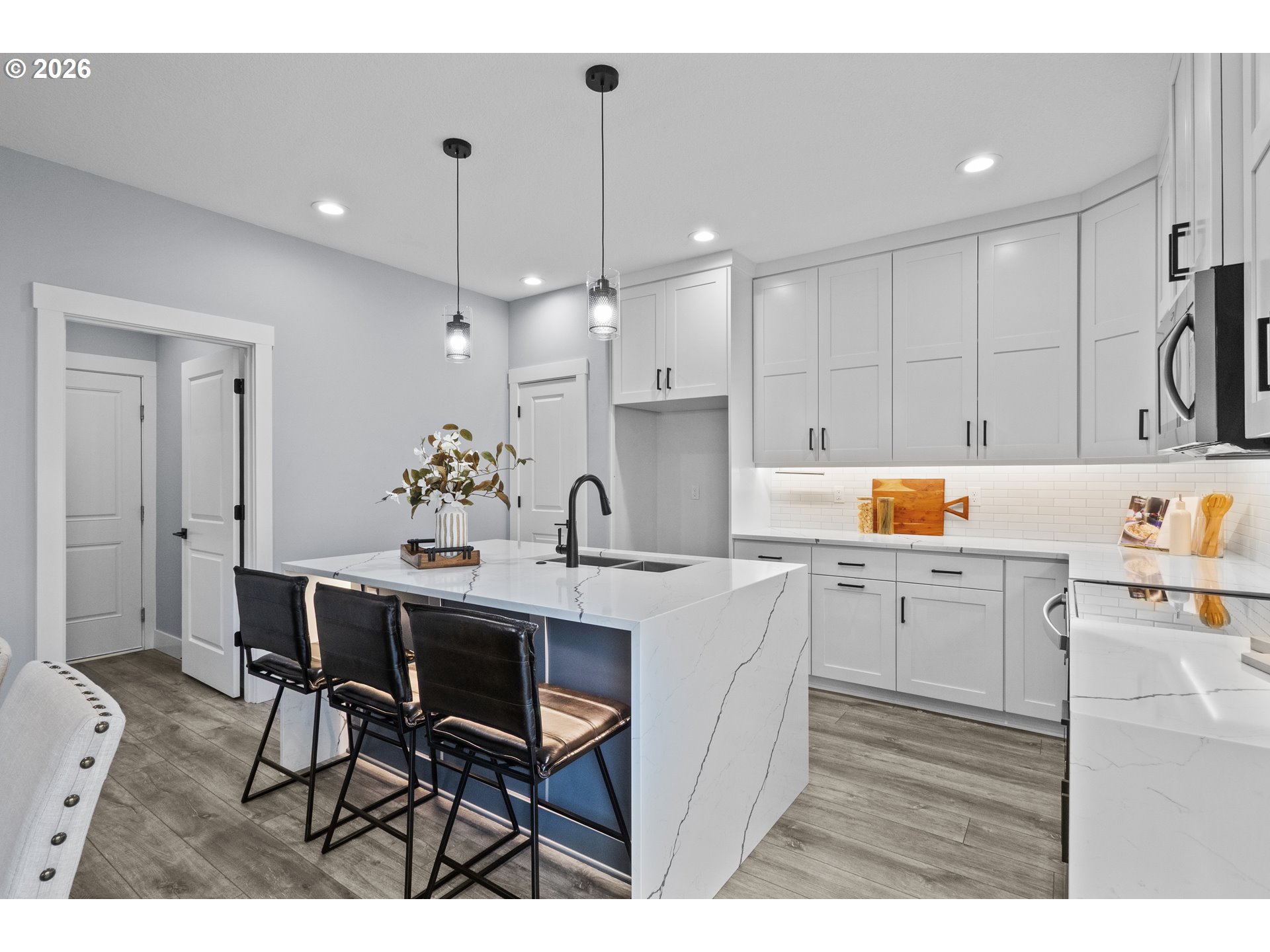 819 Riley Drive Northeast Silverton, OR 97381 - Photo 10 of 38 a kitchen with white cabinets and chairs