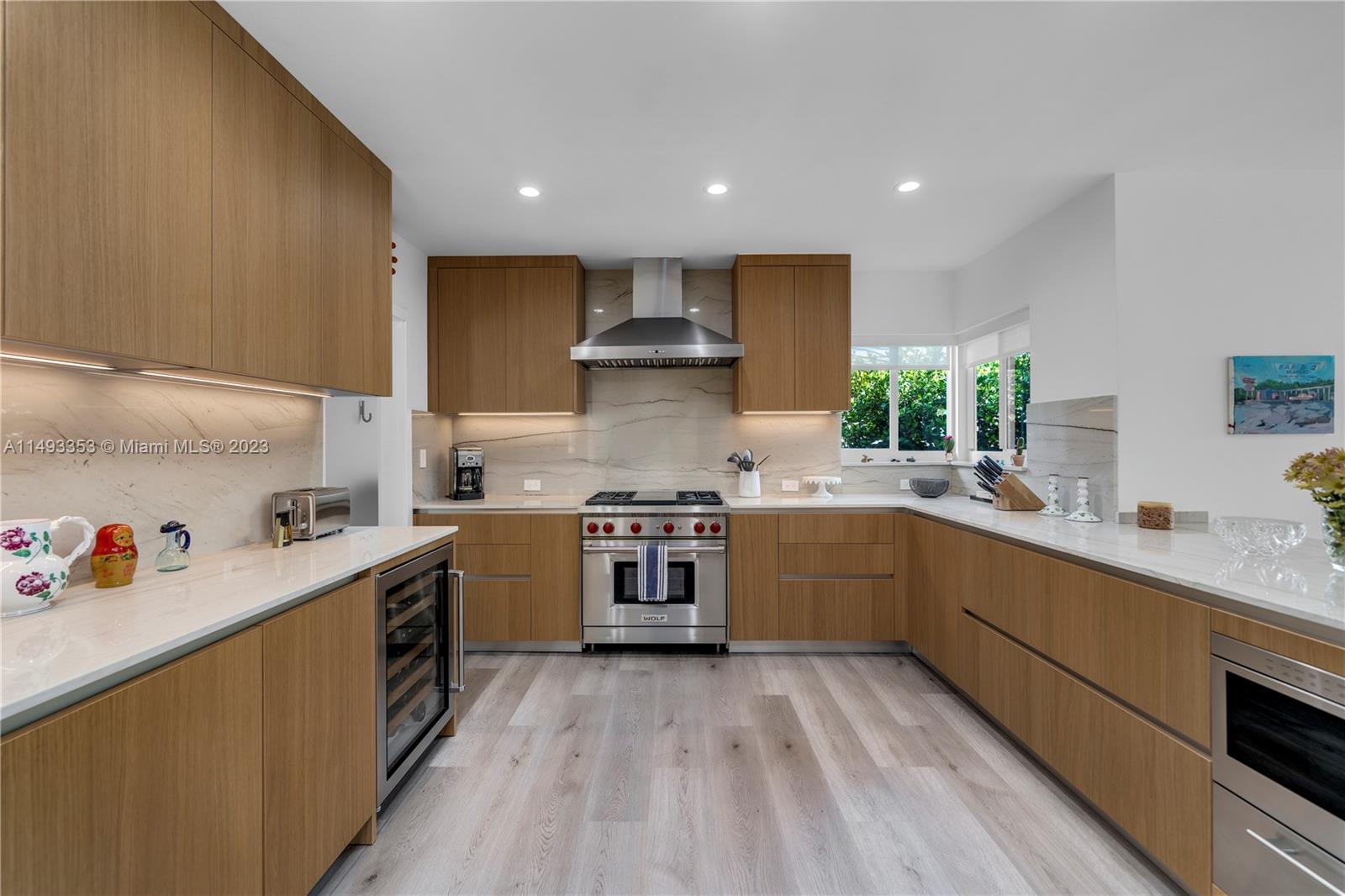 1277 Biscaya Drive Surfside, FL 33154 - Photo 6 of 13 a kitchen with a sink stove and cabinets