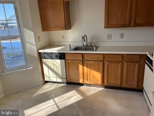 a kitchen with a sink cabinets and a stove top oven