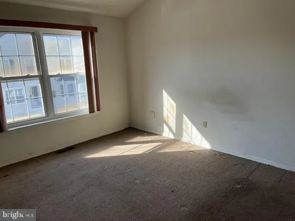 an empty room with a empty space and windows