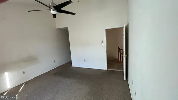 an empty room with a hallway and a closet