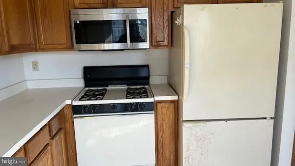 a stove top oven sitting inside of a kitchen
