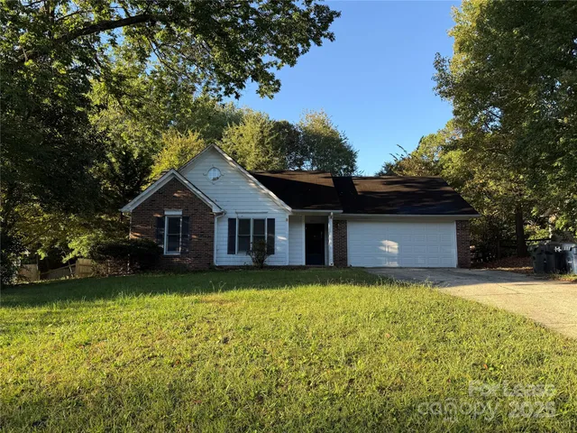 a front view of a house with yard and green space