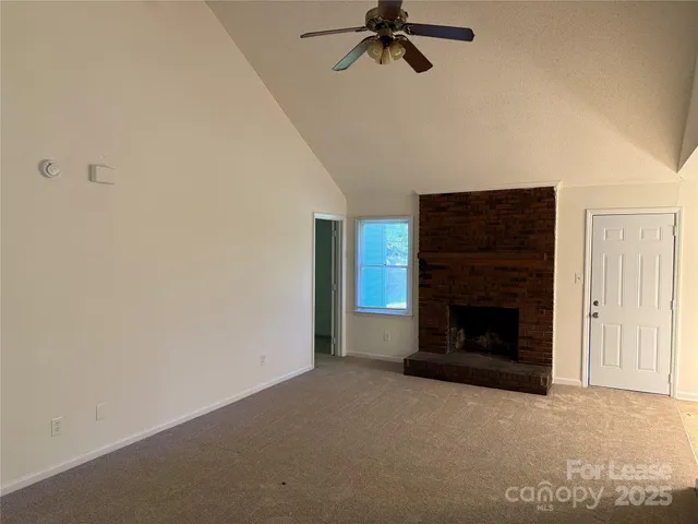 a view of empty room with a fireplace