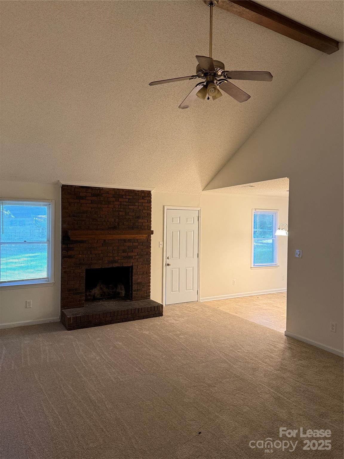 12800 Levins Hall Road Huntersville, NC 28078 - Photo 3 of 16 a view of a livingroom with a fireplace and a ceiling fan