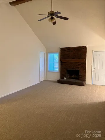 a view of empty room with fireplace