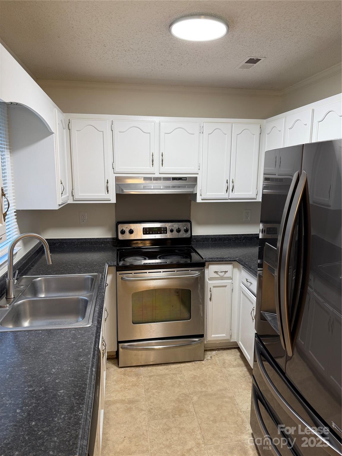 12800 Levins Hall Road Huntersville, NC 28078 - Photo 7 of 16 a kitchen with granite countertop a refrigerator sink and stove