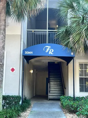 a view of a wooden door with a small yard