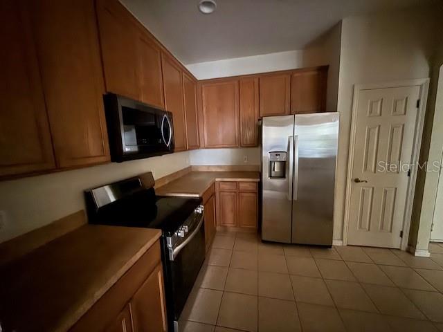 3341 Whitestone Circle, Unit 204 Kissimmee, FL 34741 - Photo 3 of 14 a kitchen with a refrigerator stove and microwave