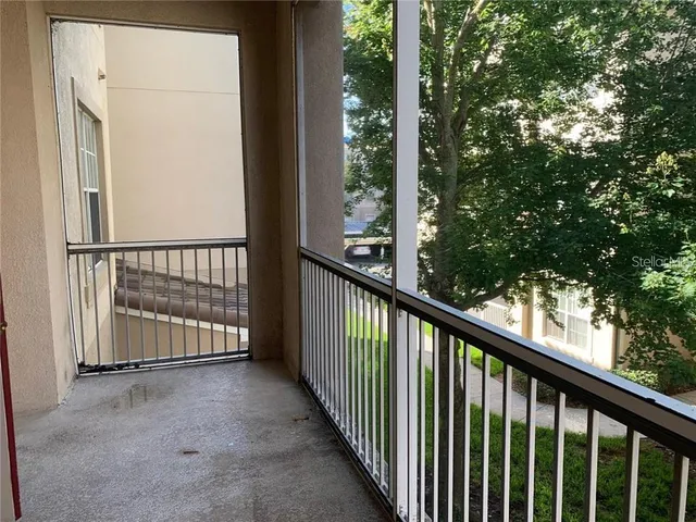 a view of a balcony with tree