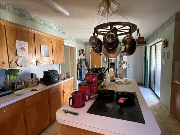 a kitchen with a sink a stove and cabinets