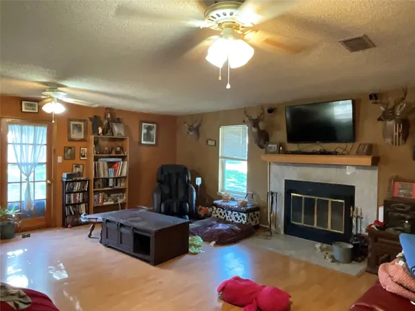 a living room with furniture a fireplace and a flat screen tv