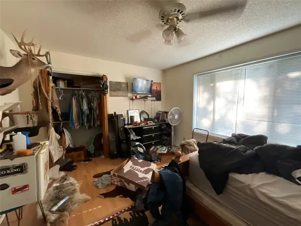 a living room with furniture a flat screen tv and a window