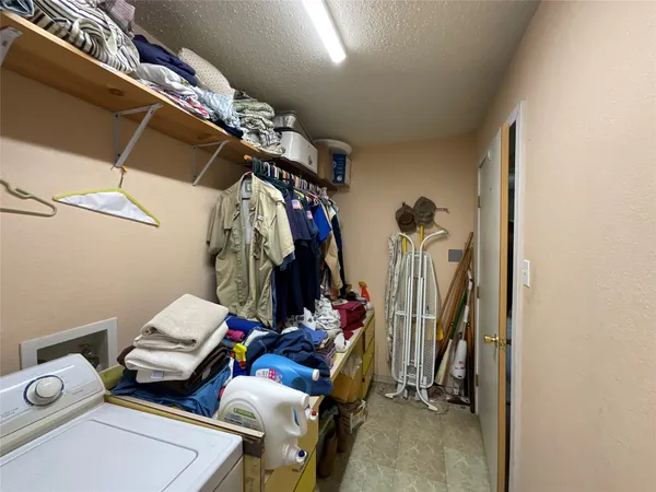 a bedroom with furniture and a lamp