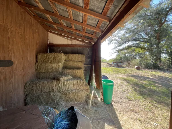 a view of a balcony with floor to ceiling windows and wooden fence