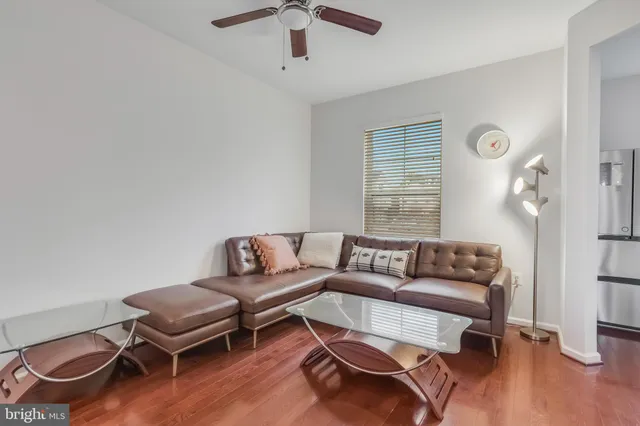 a living room with furniture and kitchen view