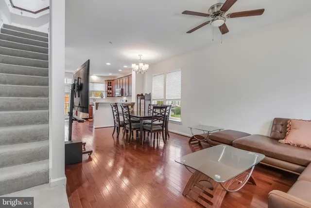 a hallway with wooden floor potted plants with wooden floor