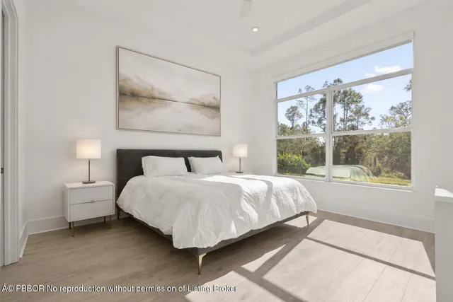 a bedroom with a large bed and a window