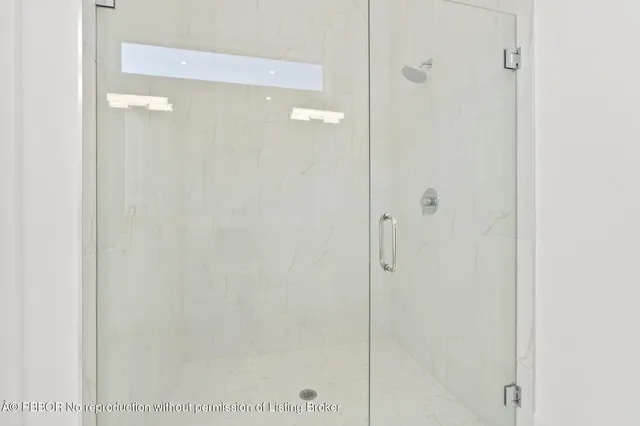 a bathroom with a glass shower door