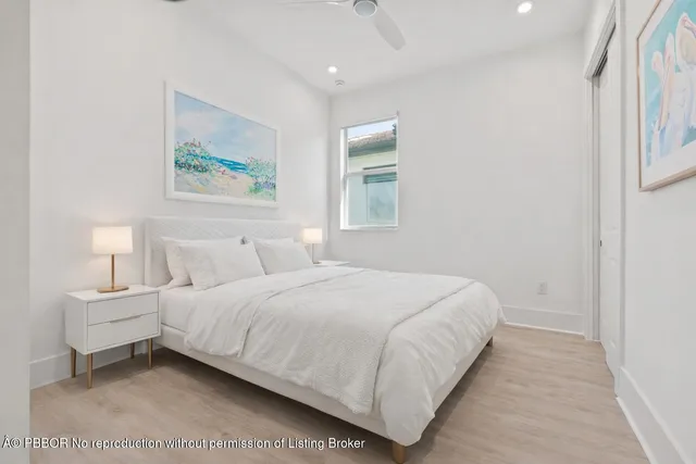 a bedroom with a bed and a painting on the wall