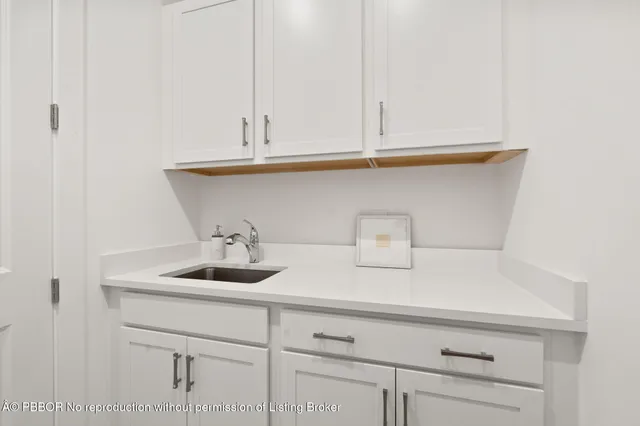 a kitchen with a sink and cabinets