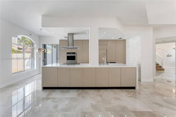 a living room with furniture and large windows