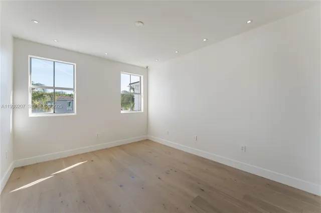 an empty room with windows and closet